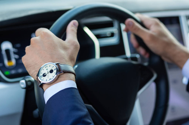 Close up of businessman holding steering wheel - Photo, Image