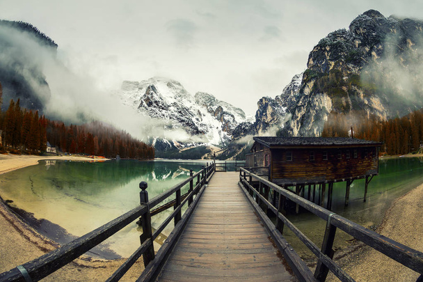 Braies Lake in Dolomites mountains forest trail in background, Sudtirol, Italy. Lake Braies is also known as Lago di Braies. The lake is surrounded by forest which are famous for scenic hiking trails. - Photo, Image