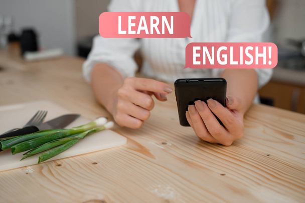 Conceptual hand writing showing Learn English. Business photo showcasing gain acquire knowledge in new language by study woman using smartphone and technological devices inside home. - Photo, Image