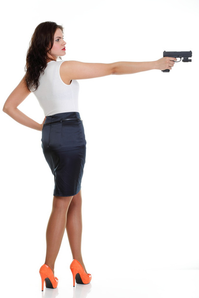 Young brunette woman with gun isolated on white - Foto, afbeelding