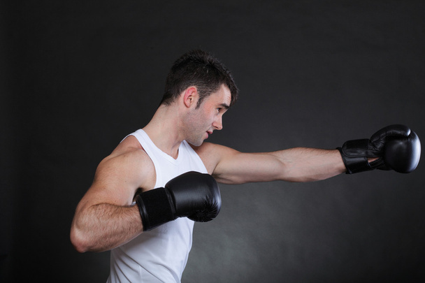 Portrait sportsman boxer in studio dark background - Foto, imagen