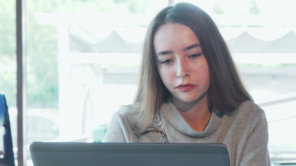 Beautiful woman looking stressed while working on laptop - Filmmaterial, Video