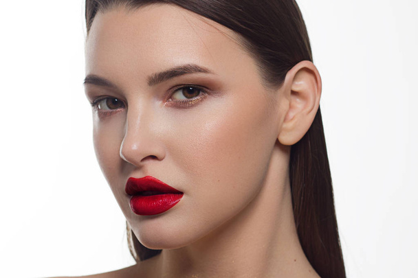 Close-up portrait of sexy european young woman model with classic glamour make-up and red lipstick. Dark long hairstyle, christmas makeup, dark eyeshadows, bloody red lips with gloss - Fotoğraf, Görsel