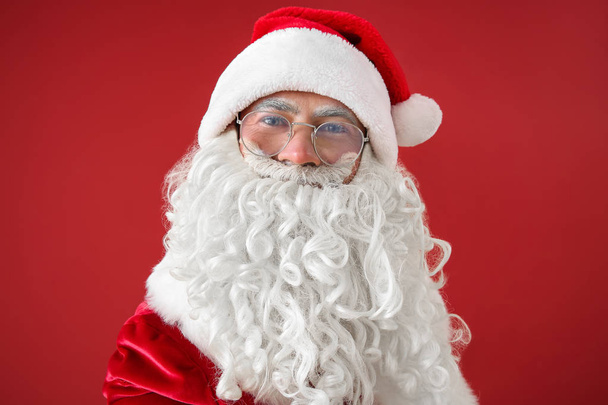 Portrait of Santa Claus taking selfie on color background - Foto, afbeelding