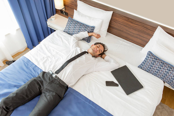Success, good news, businessman celebrating in a hotel room - Photo, image