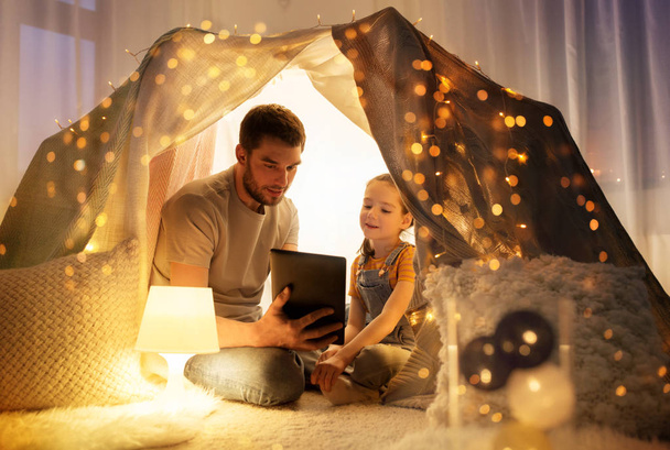 family with tablet pc in kids tent at home - Φωτογραφία, εικόνα