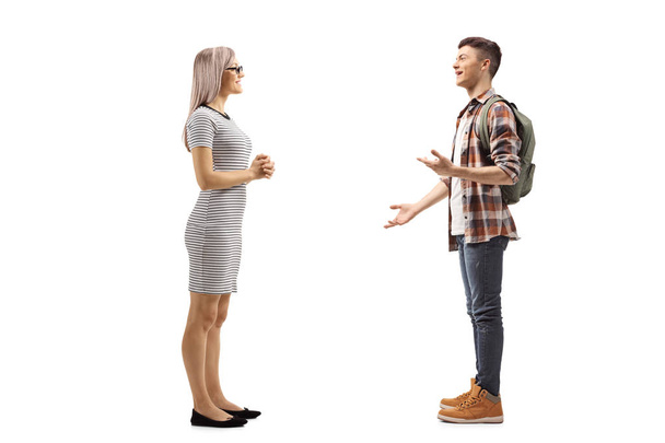 Young woman listening to a male student explaining and gesturing - Photo, Image
