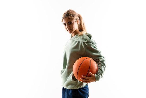 Teenager girl playing basketball over isolated white background - Photo, Image