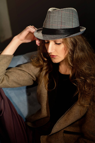 Young beautiful girl posing in hat,studio projector - Фото, зображення