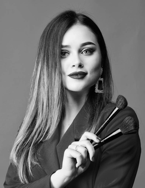Looking good and feeling confident. Gorgeous lady makeup red lips. Attractive woman applying makeup brush. Strengthen confidence with bright makeup. Perfect skin tone. Makeup artist concept - Fotografie, Obrázek