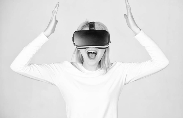 Excited smiling businesswoman wearing virtual reality glasses. Woman watching virtual reality vision. A person in virtual glasses flies in room space. VR headset. - Fotoğraf, Görsel