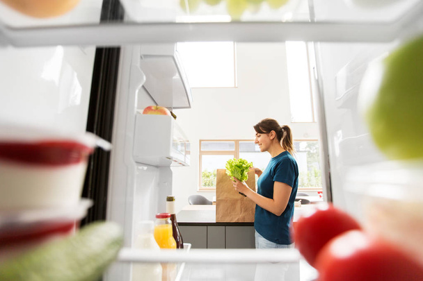 view to woman with purchased food from home fridge - Fotografie, Obrázek