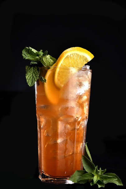 ALCOHOLIC DRINK WITH FRUIT COCKTEL on black background - Photo, Image