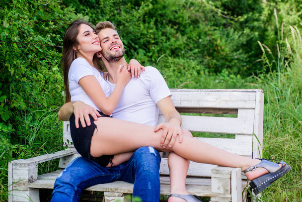 Sensual hug. Love and romance concept. Summer vacation. Romantic date in park. Handsome man pretty girl in love. Relaxing with darling. Lovers cuddling. Couple in love sit bench. Trust and intimacy - Fotó, kép