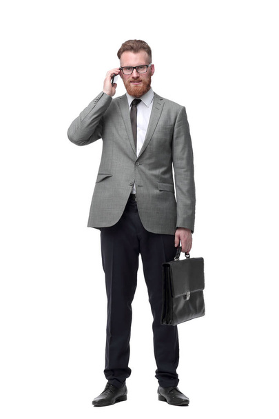 confident businessman with briefcase . isolated on white background - Zdjęcie, obraz