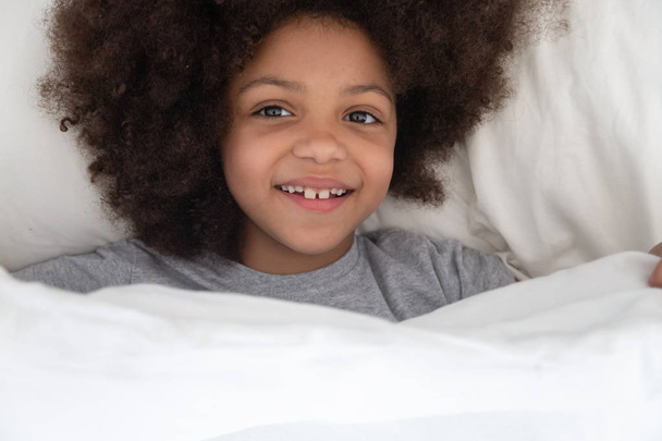 Boldog afro-amerikai gyerek lány ébredezik reggel. - Fotó, kép