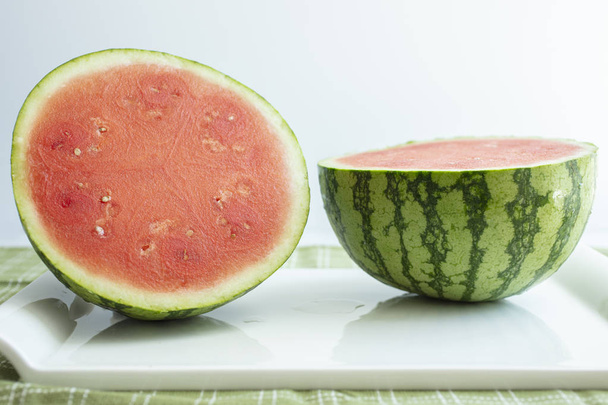 Watermelon cut in half on a table top - Photo, Image