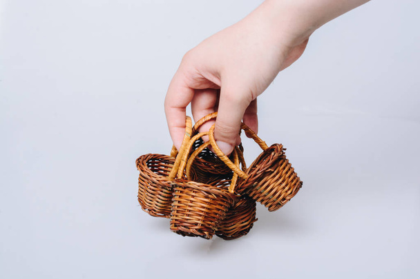 Empty wicker baskets in hand on a white background - Photo, Image