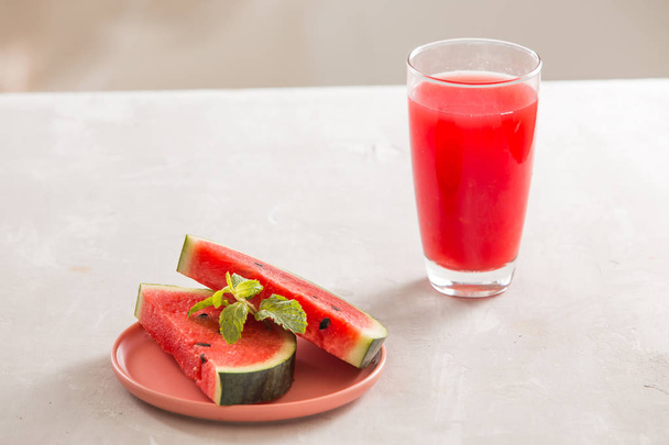 Watermelon juice, watermelon slices and mint leaves. - Fotoğraf, Görsel