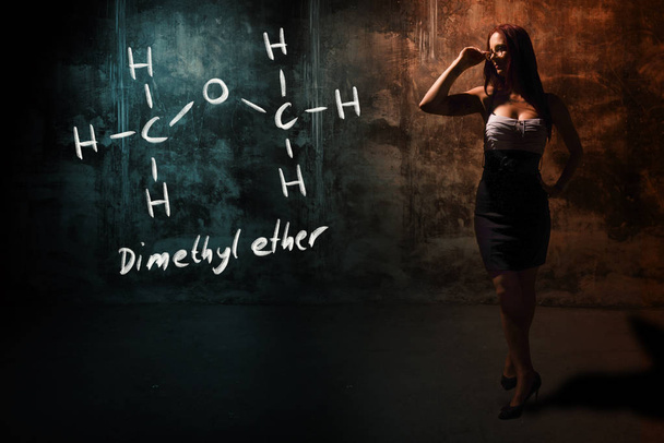 Sexy girl or secretary or female student presenting handdrawn chemical formula of Dimethyl ether methoxymethane DME - Fotó, kép