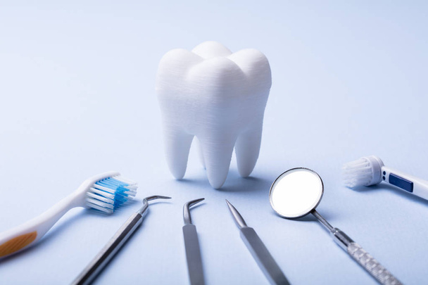 Dental Model And Dental Equipment On Blue Background - Foto, Imagem
