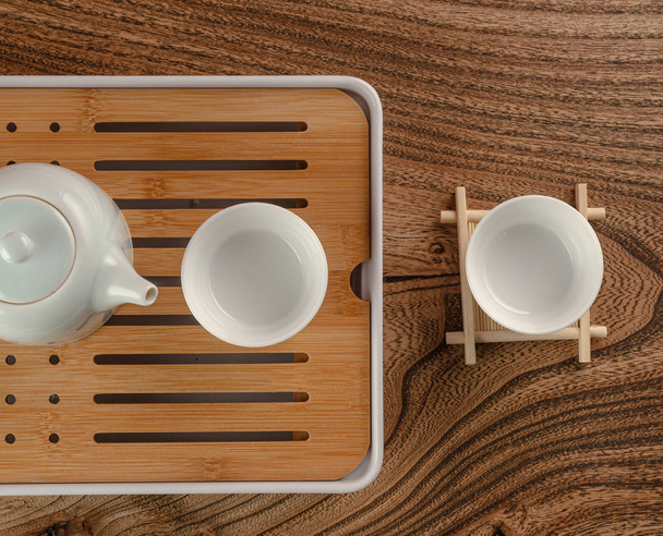 the tea table with instruments teapots cups and green tea - Фото, изображение