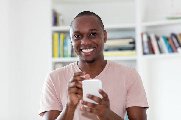 African american bald headed mature man sending sms - Valokuva, kuva