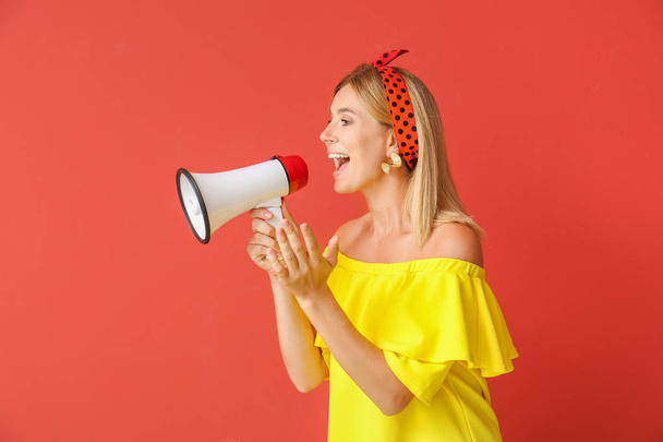 Screaming woman with megaphone on color background - Photo, image