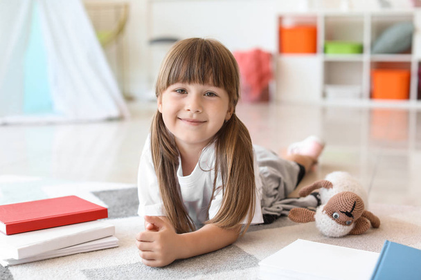 Cute little girl with books at home - Foto, Bild