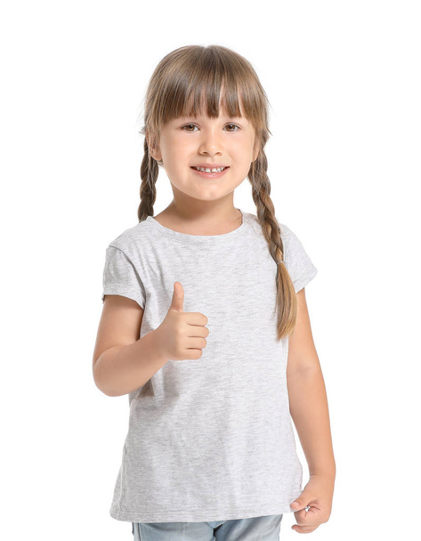 Little girl in stylish t-shirt showing thumb-up on white background - 写真・画像