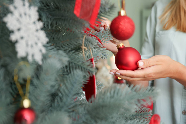 Woman decorating beautiful Christmas tree at home, closeup - Fotografie, Obrázek