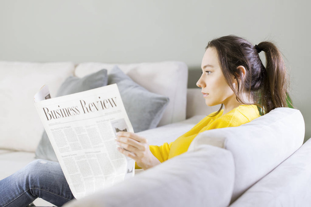 Woman reading the newspaper at home - Foto, Imagem