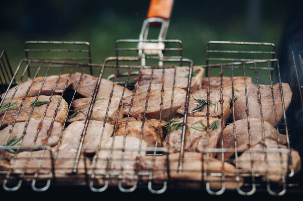 Meat barbecue on grill.Close-up of meat preparing on BBQ grill equipment outdoors. BBQ party concept. - Photo, Image