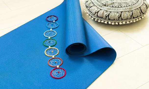 Blue yoga mat and seven chakra decoration. Yoga concept. - Photo, Image