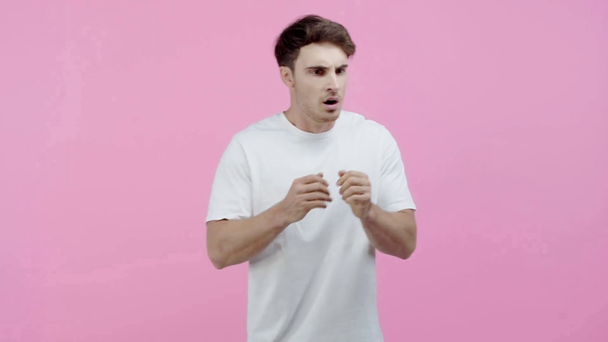 vyděšený šokovaný muž izolovaný na růžovém - Záběry, video