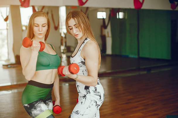 two sporty girls in a gym - Valokuva, kuva