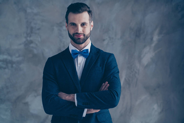 Portrait of charming guy crossing his hands looking wearing modern classy bow tie blazer jacket isolated over grey background - Fotografie, Obrázek