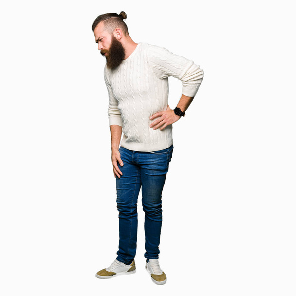 Young hipster man wearing winter sweater Suffering of backache, touching back with hand, muscular pain - Foto, Imagen