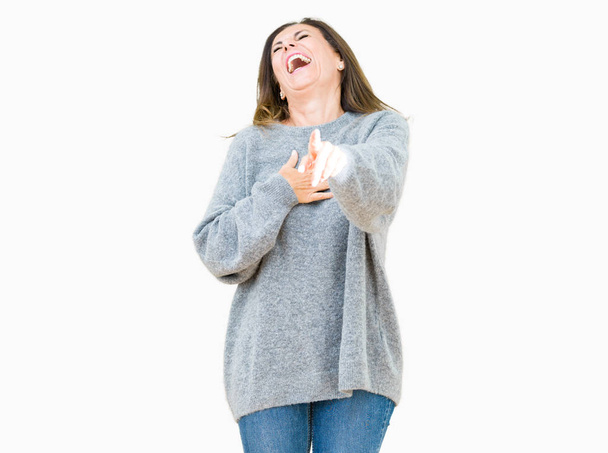 Beautiful middle age woman wearing winter sweater over isolated background Laughing of you, pointing to the camera with finger hand over chest, shame expression - Foto, afbeelding