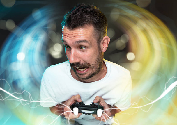 Enthusiastic gamer. Joyful young man holding a video game controller - Фото, зображення