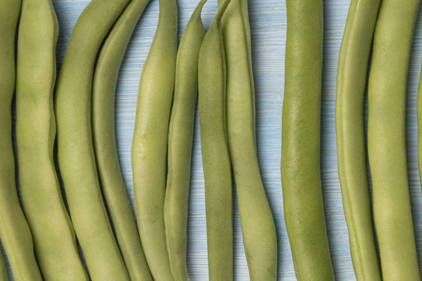 Green beans on blue wood background  - Photo, Image