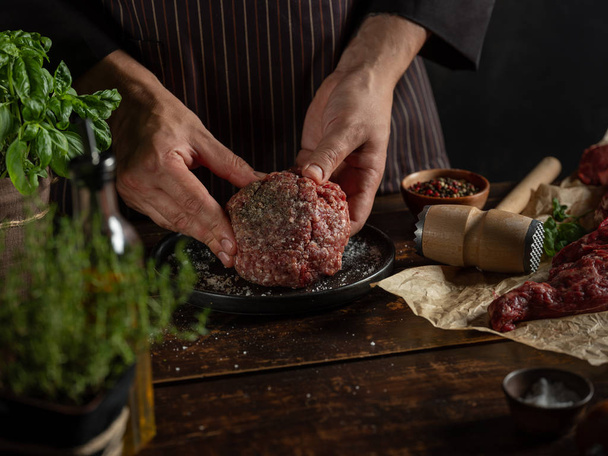 Chef preparing minced meat with spices and herbs - Φωτογραφία, εικόνα