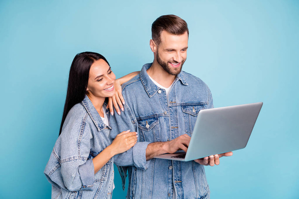 Photo of charming beautiful nice cute fascinating couple wearing jeans denim jackets searching for information about relaxing abroad while isolated with blue background - Fotoğraf, Görsel