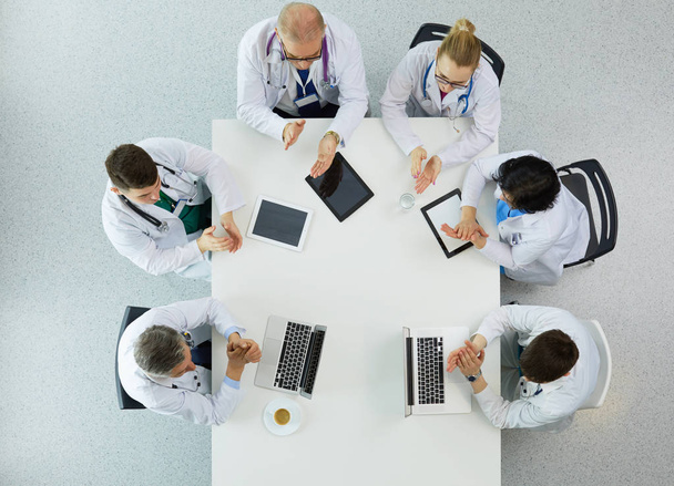 Medical team sitting and discussing at table, top view - Fotoğraf, Görsel