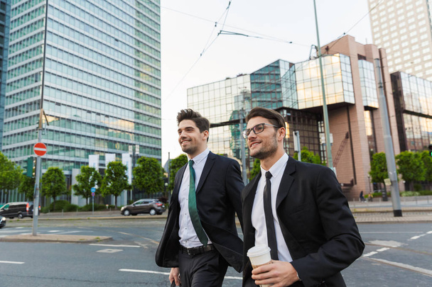 Two attractive young businessmen wearing suits - Foto, Imagen