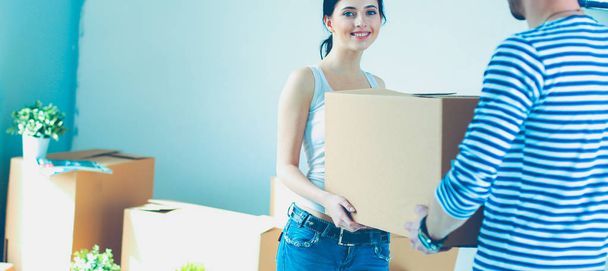 Happy young couple unpacking or packing boxes and moving into a new home. young couple - Fotoğraf, Görsel
