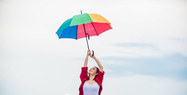 Ready for new adventures. autumn fashion. Rainbow umbrella protection. carefree time spending. pretty woman with colorful umbrella. rainy weather. Fall positive mood. autumn weather forecast - 写真・画像