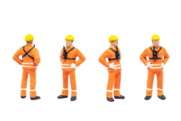 Group of Miniature figurine character as railway shunter standing and posing in posture isolated on white background. - 写真・画像