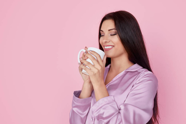 Smiling woman enjoying drink in morning - Zdjęcie, obraz