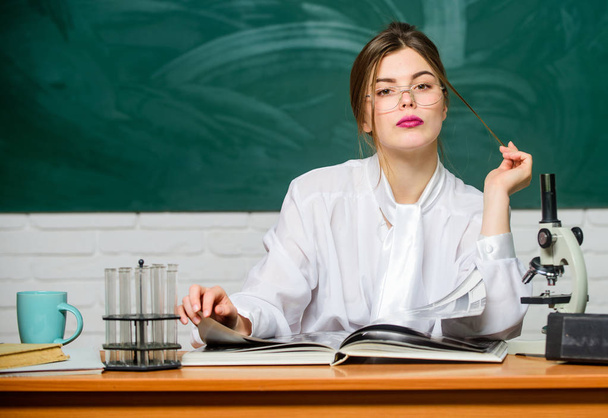 Chemist biologist with microscope. Smart student. Study hard. Education concept. Woman pretty adorable teacher or student. Scientific research. Biology student sit classroom chalkboard background - 写真・画像